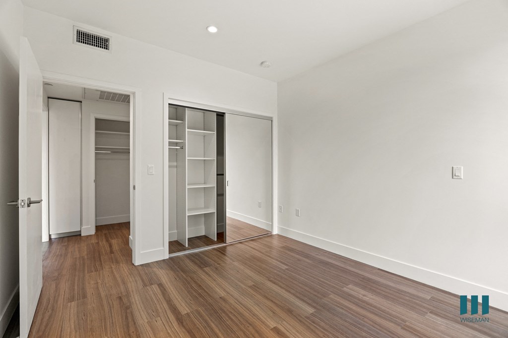Bedroom with Closet with Shelving, Recessed Lighting, and Vinyl Flooring