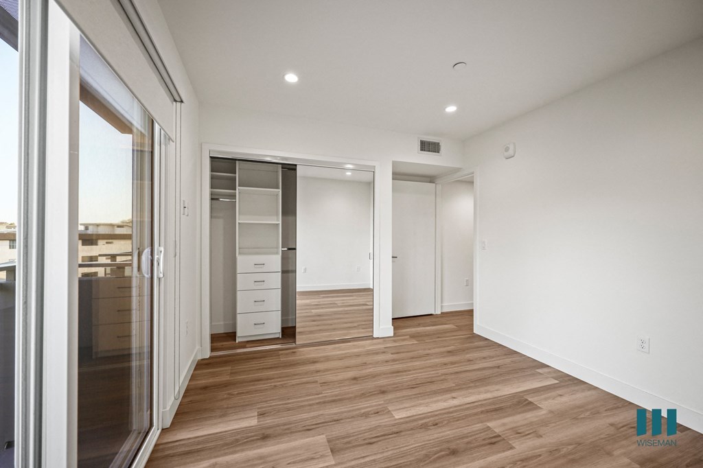 A room with a wooden floor and white walls.