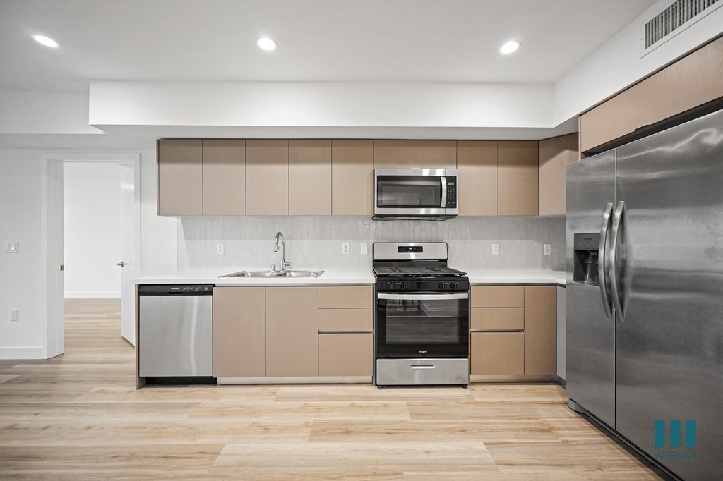 A modern kitchen with a stainless steel refrigerator.