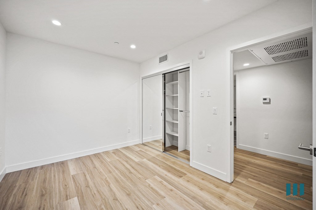 A room with a wooden floor and white walls.