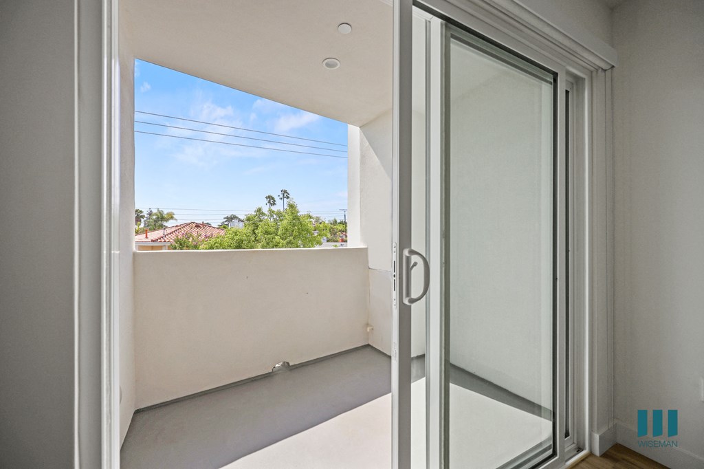 a balcony with a view of a blue sky and a window