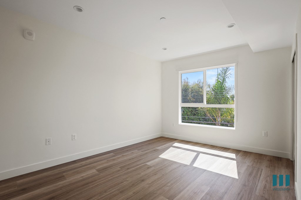 a room with large windows and a wooden floor