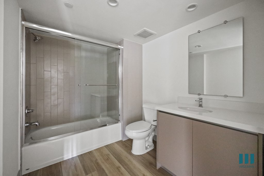 a bathroom with a shower and a sink and a toilet