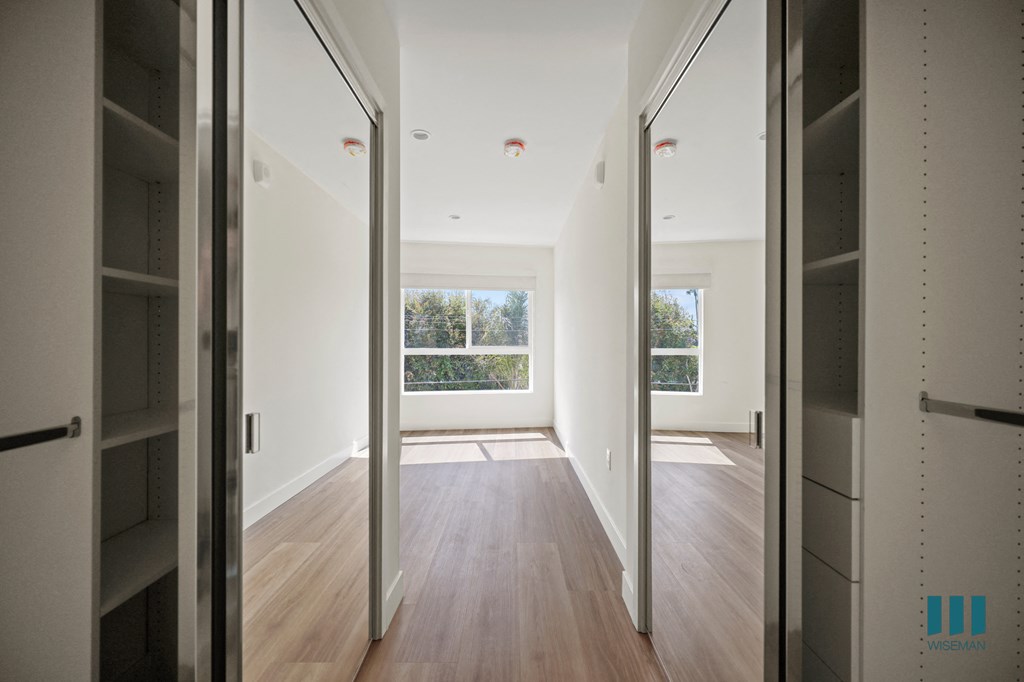 a view of a living room from a hallway with mirrored doors