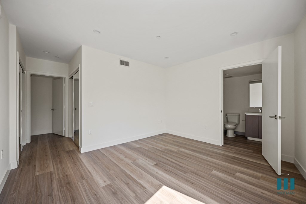 a view of a room with white walls and a wood floor