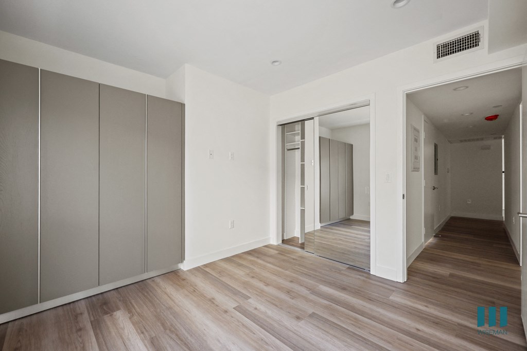 a renovated apartment with white walls and wood floors