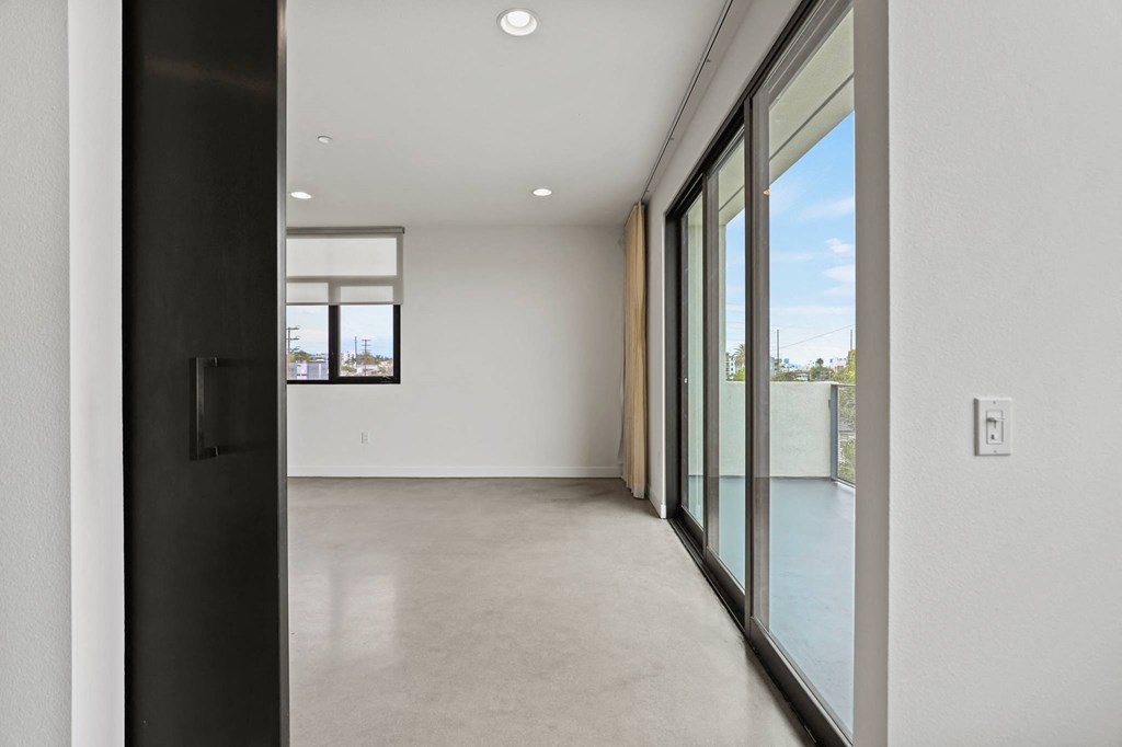 Bedroom Leading to Living Room with Patio and Lots of Natural Light