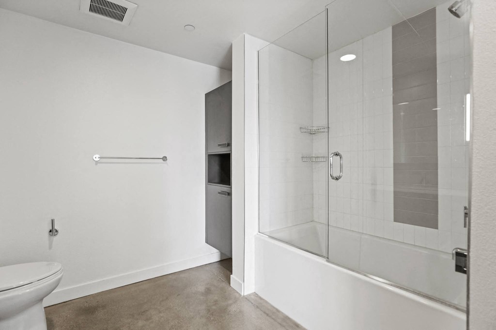 Bathroom with Shower Bath with Glass Door and Built-In Cabinet Storage
