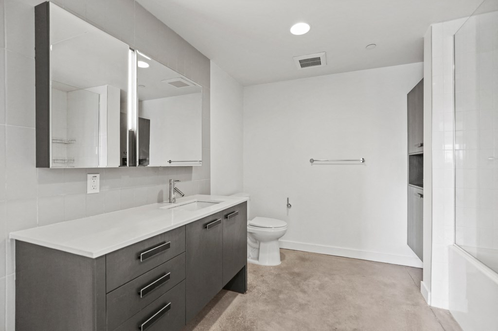 Bathroom with Full-Size Shower Bath with Glass Door and Built-In Cabinet Storage