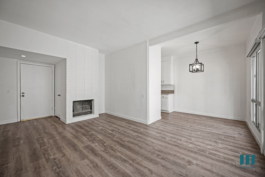 A room with a fireplace and a chandelier.