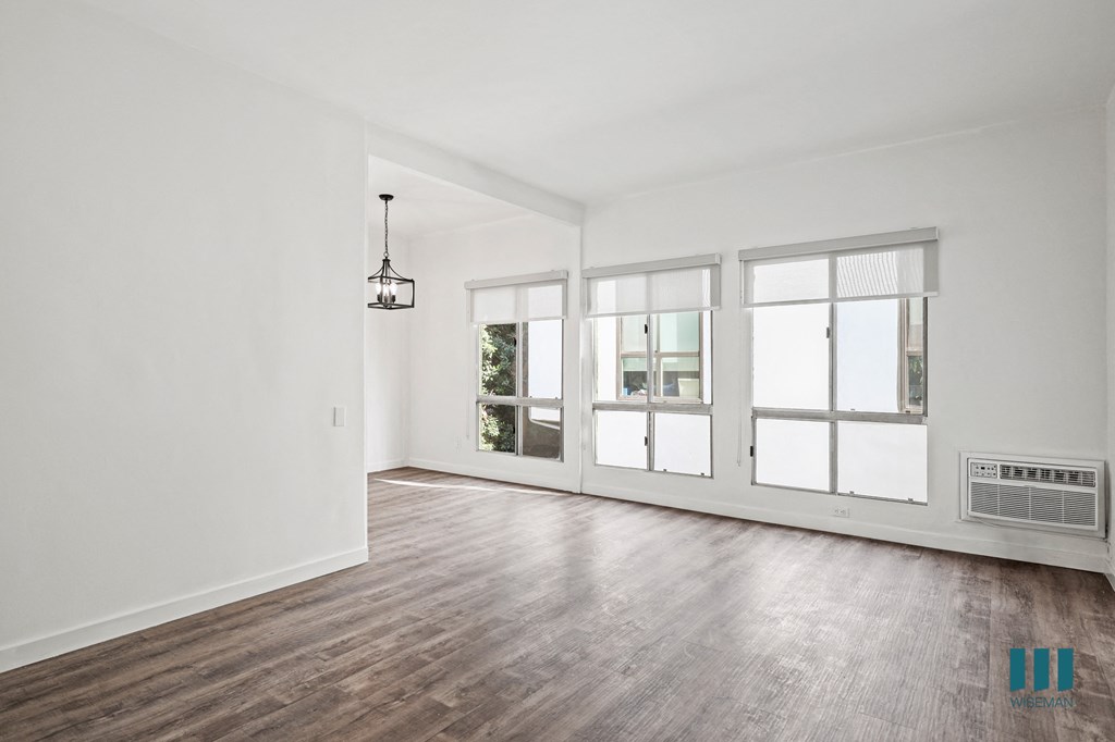 A room with a wooden floor and a large window.