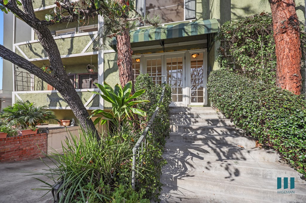 A house entrance with a green awning and a white door.