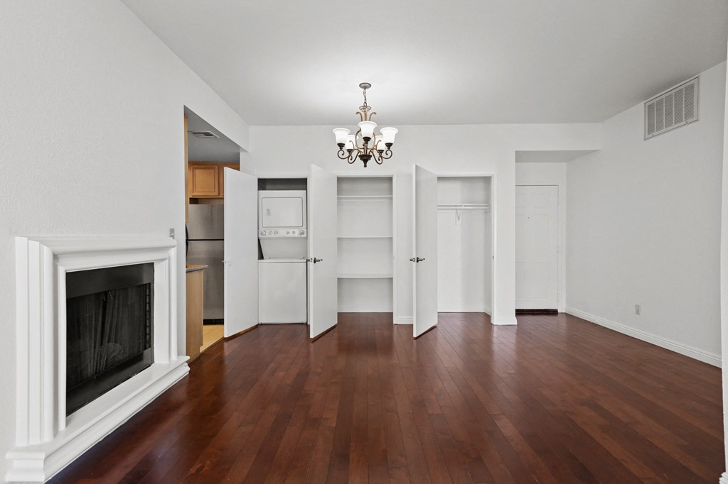 a living room with a fireplace and a wooden floor