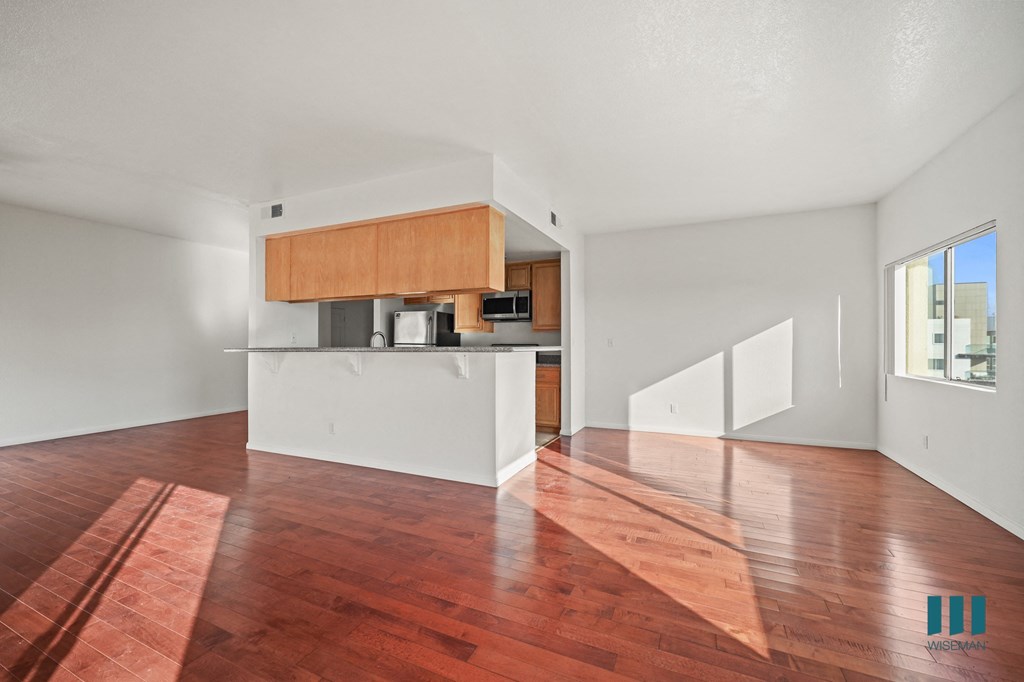 A room with a wooden floor and a white wall.