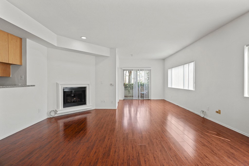 a living room with a fireplace and wooden floors