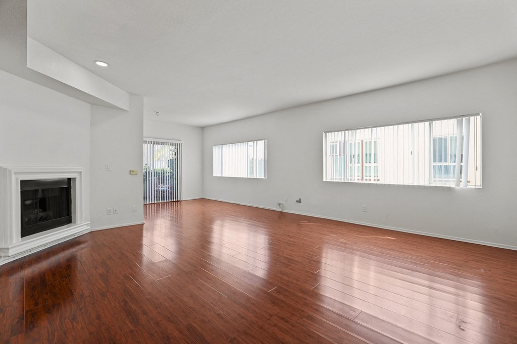 a living room with wood floors and a fireplace