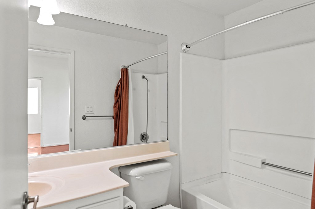 a bathroom with a shower and a sink and a toilet