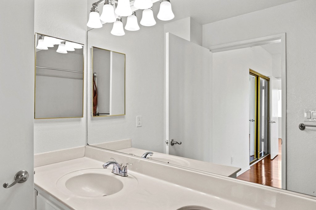 an empty bathroom with a sink and a mirror