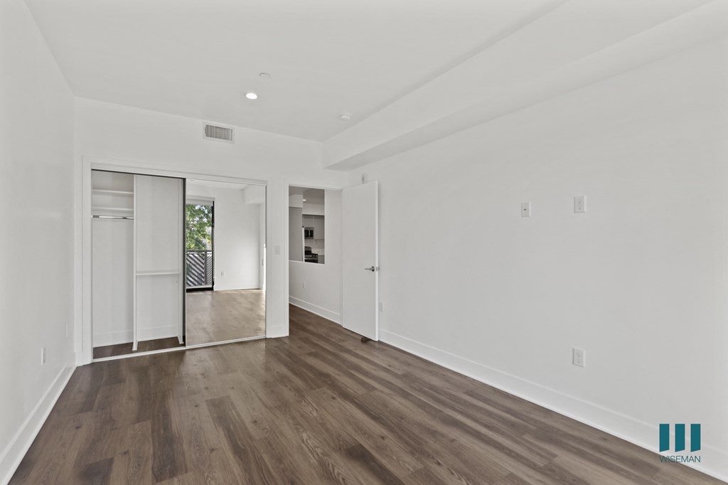 Bedroom with Mirrored Closet, Recessed Lighting, and Vinyl Flooring