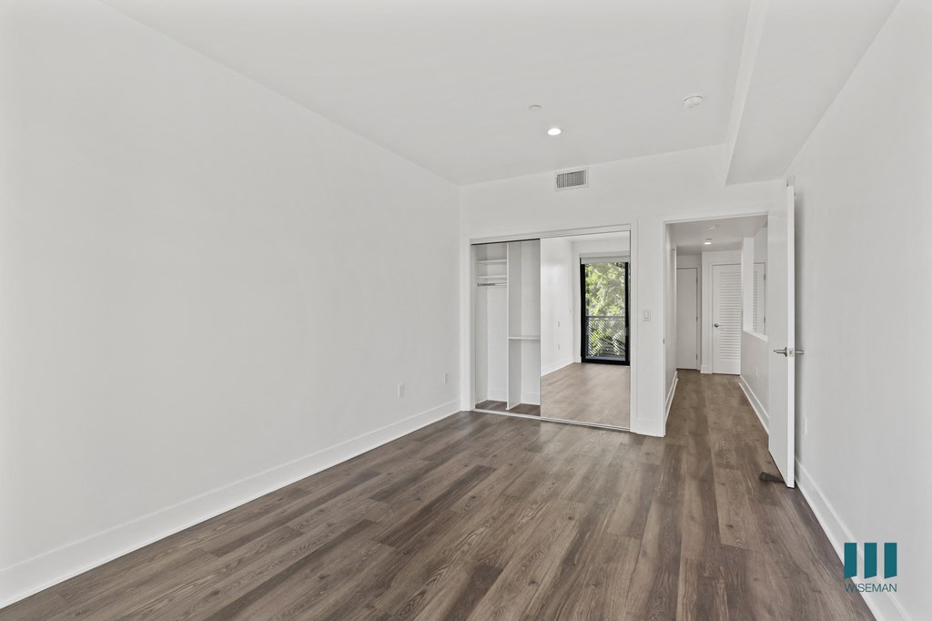 Bedroom with Mirrored Closet, Recessed Lighting, and Vinyl Flooring