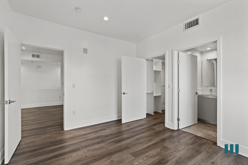 Bedroom with Bathroom, Walk-In Closet, and Vinyl Flooring
