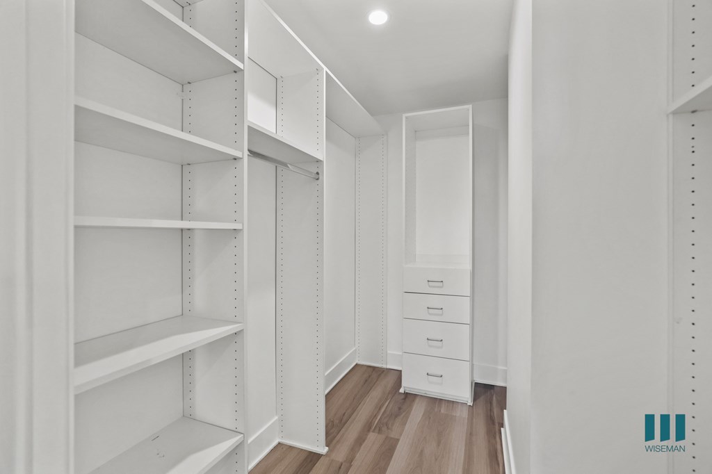 Walk-In Closet with Built-In Organizers and Shelving