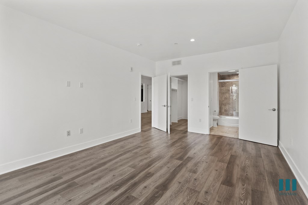 Bedroom with Bathroom, Walk-In Closet, and Vinyl Flooring