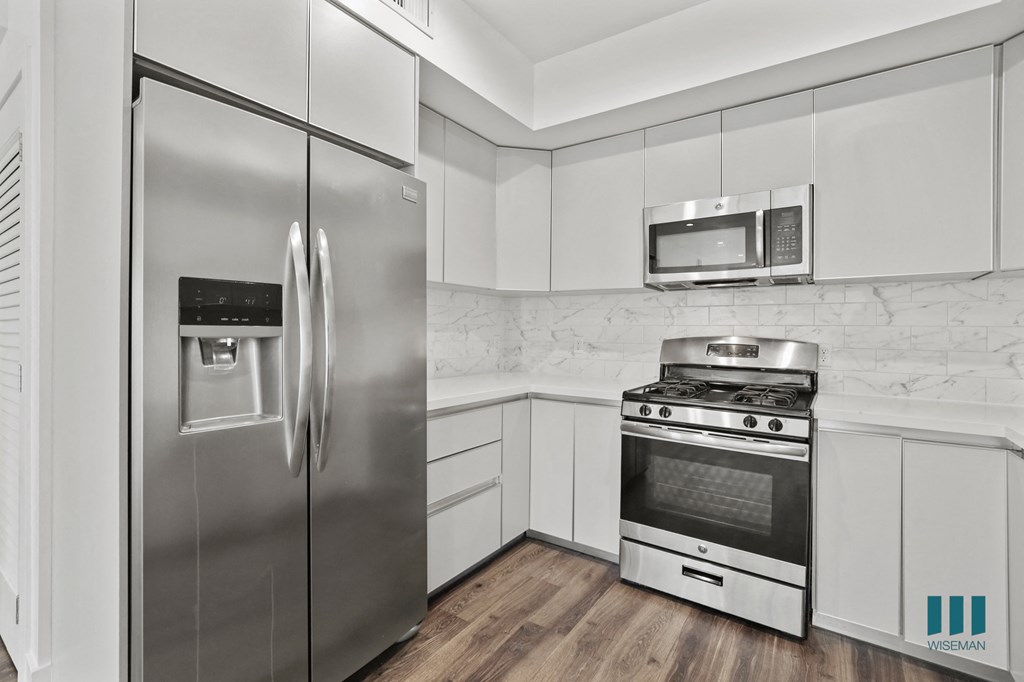 Kitchen with Stainless-Steel Refrigerator, Stove, and Microwave Oven