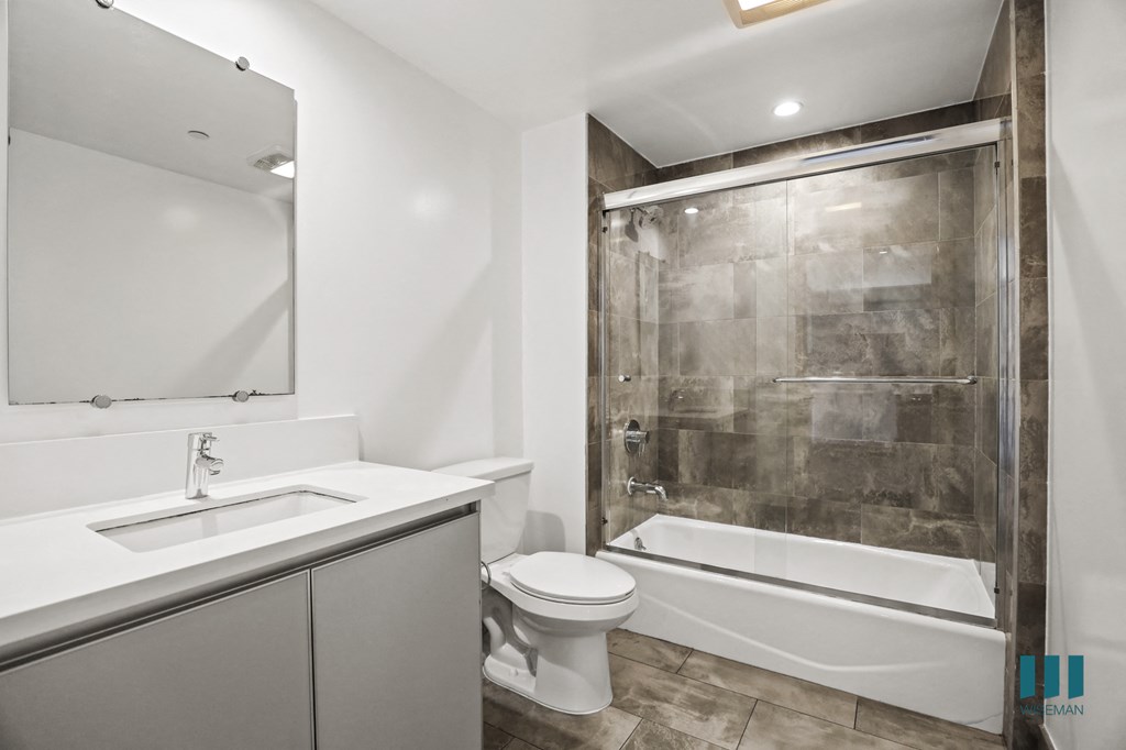 Bathroom with Shower Bath with Glass Door, and Vanity Cabinet Storage