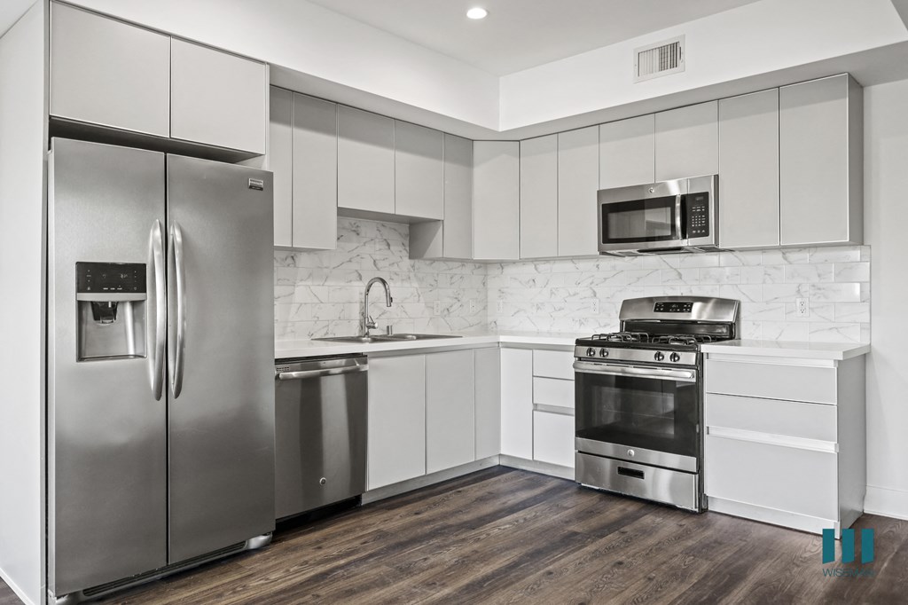 Kitchen with Energy-Efficient Refrigerator, Dishwasher, Stove, and Microwave Oven