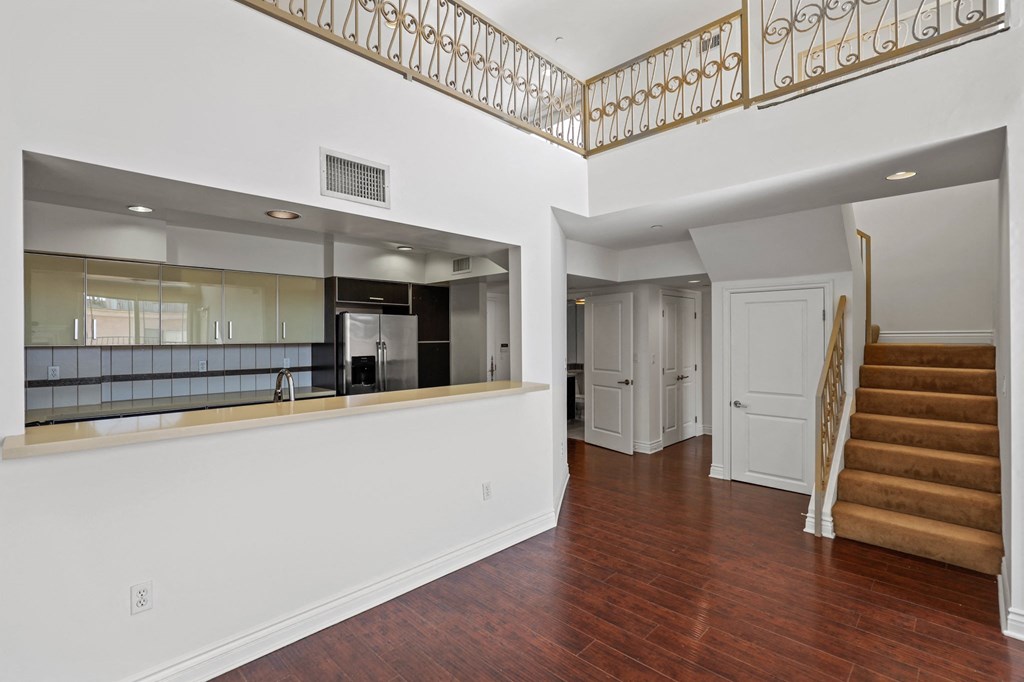 Open-Concept Kitchen and Staircase to Loft Space