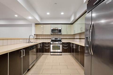 a large kitchen with stainless steel appliances and counter tops