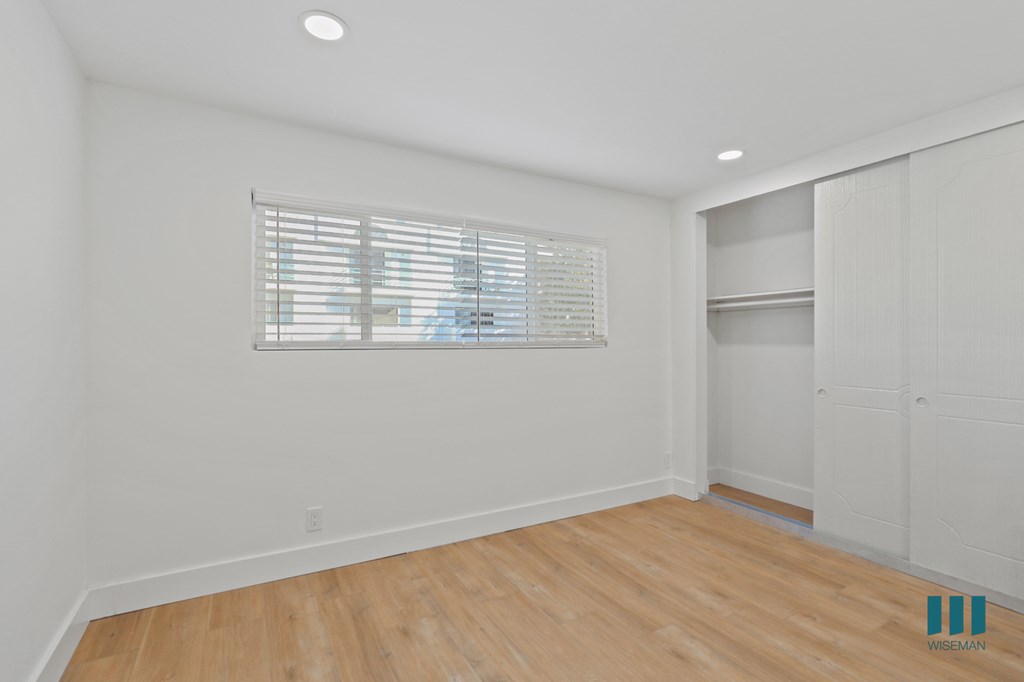 Bedroom with Closet, Recessed Lighting, Vinyl Flooring, and Windows