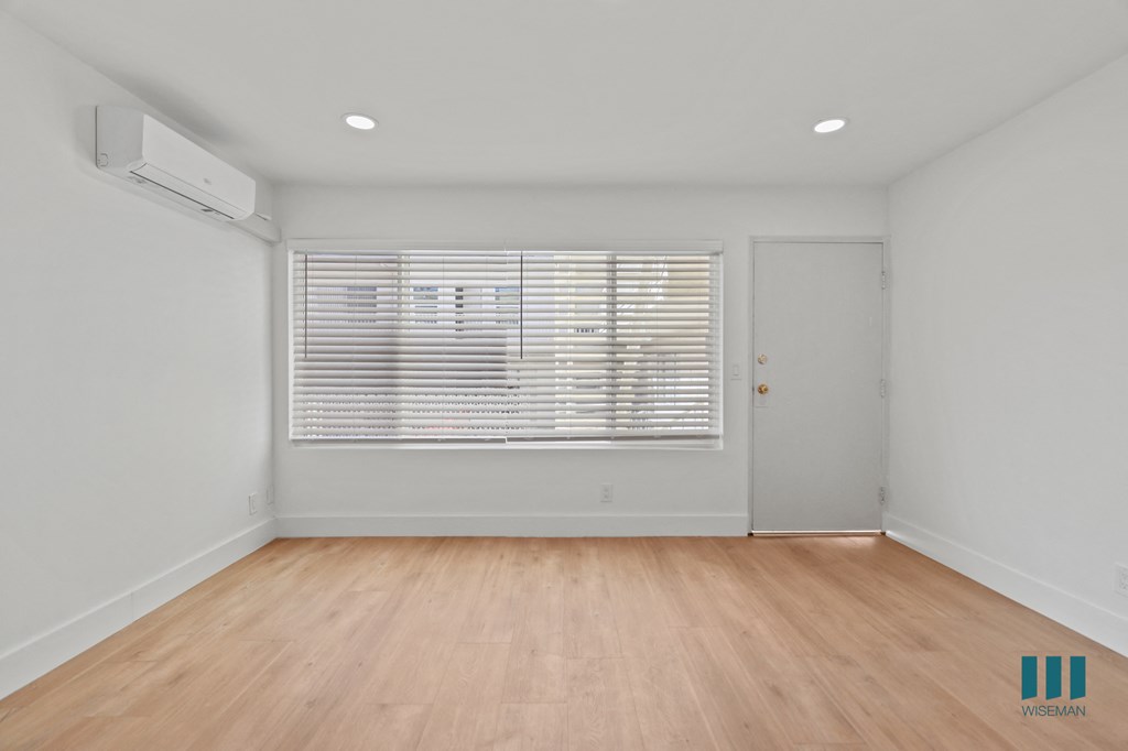 Front Entrance in Living Room with Vinyl Flooring and Large-Size Windows