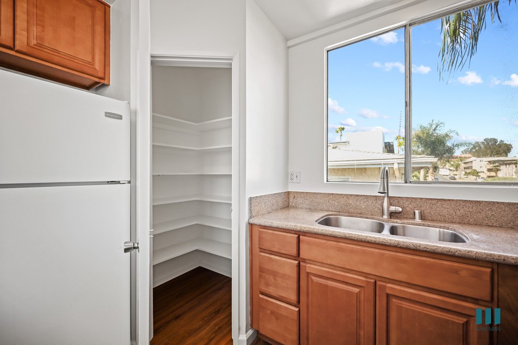 Kitchen with a Pantry Closet, refrigerator, and Large-Size Windows