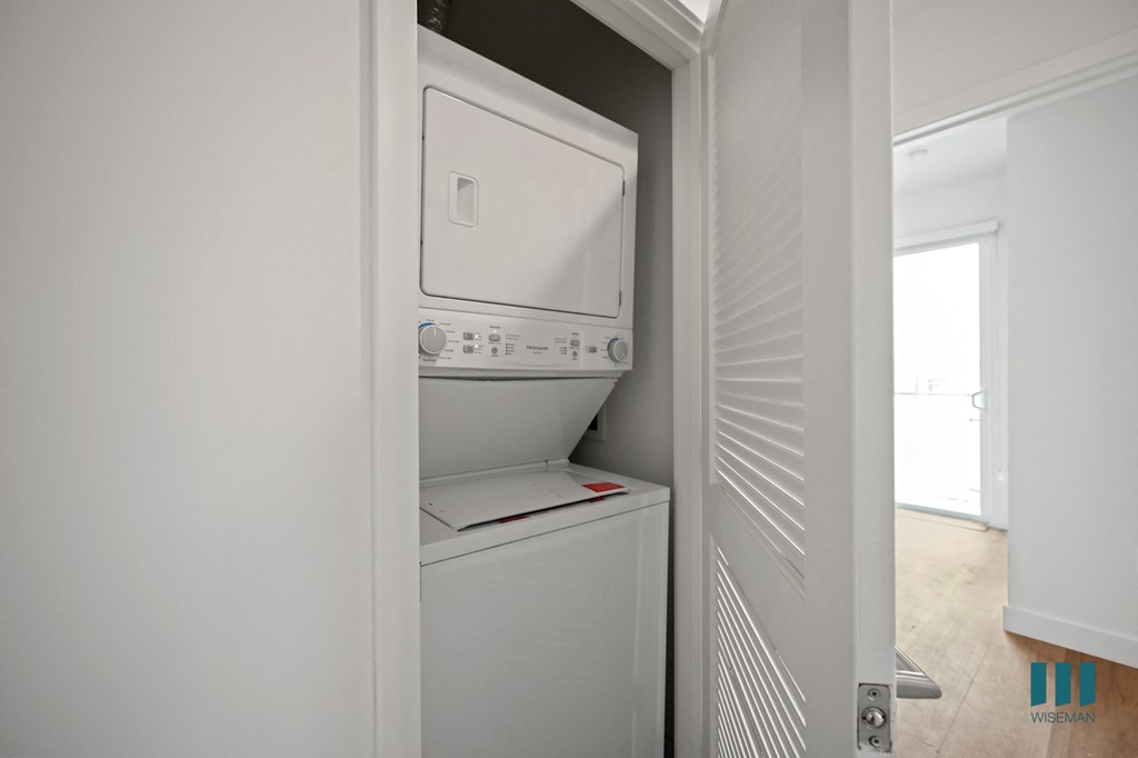 an empty laundry room with a washer and dryer