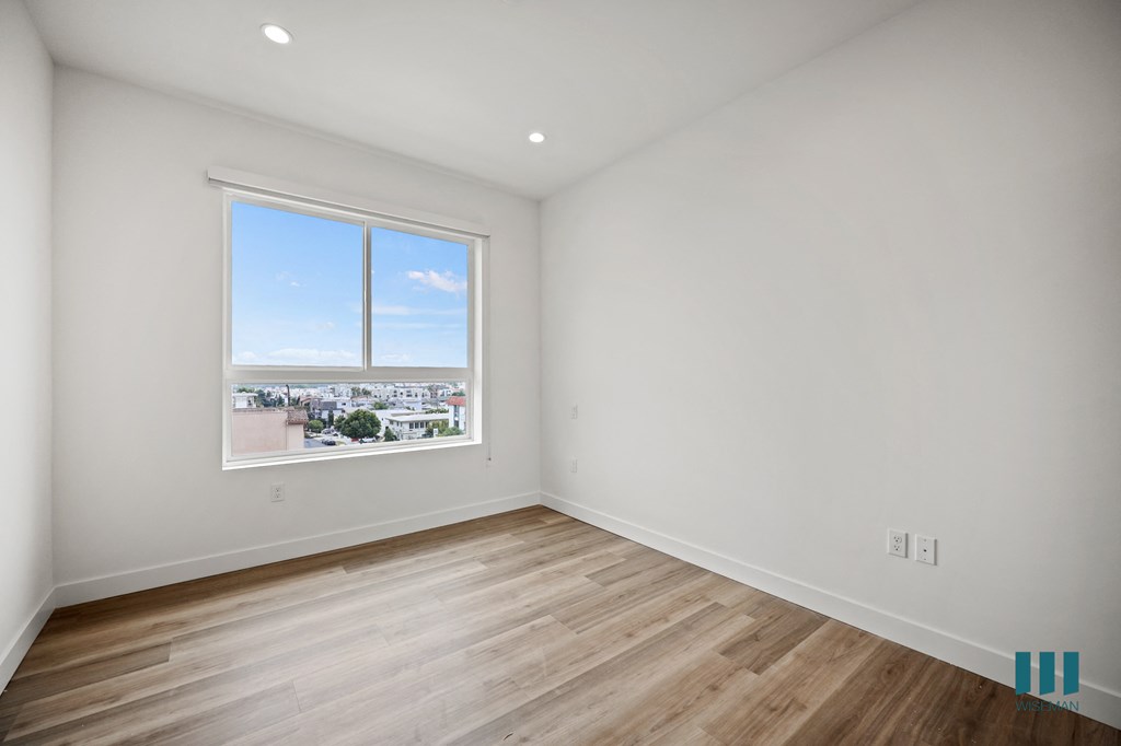 a living room with white walls and a window