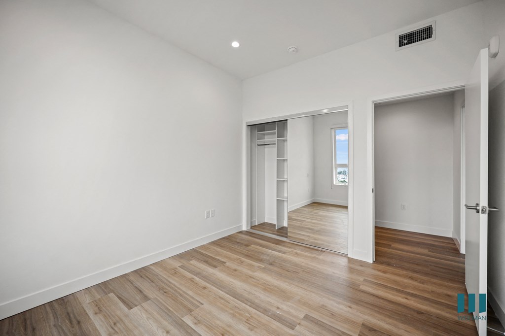 a living room with white walls and wood flooring