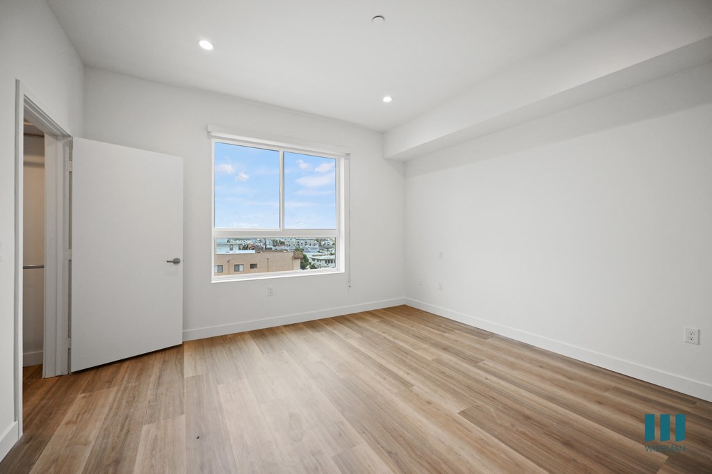 a view of a room with a window and a wooden floor