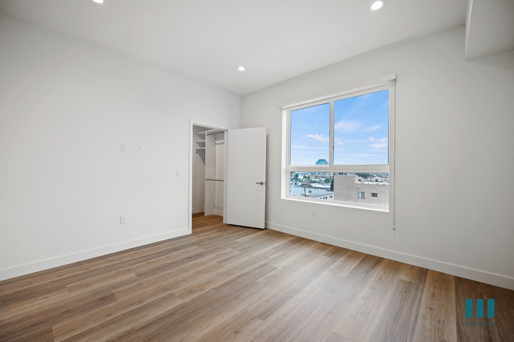 a living room with wood floors and a large window