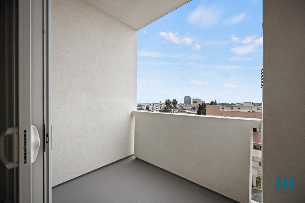 a balcony with a door and a view of the city