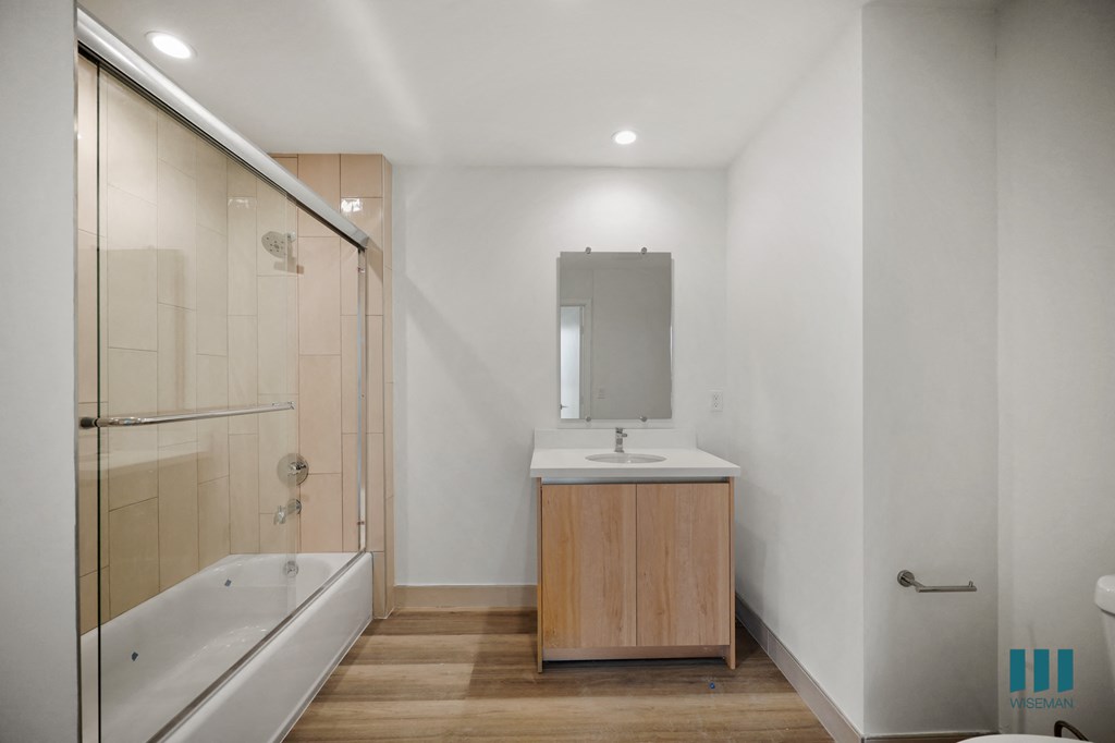 a bathroom with a sink and a tub and a shower
