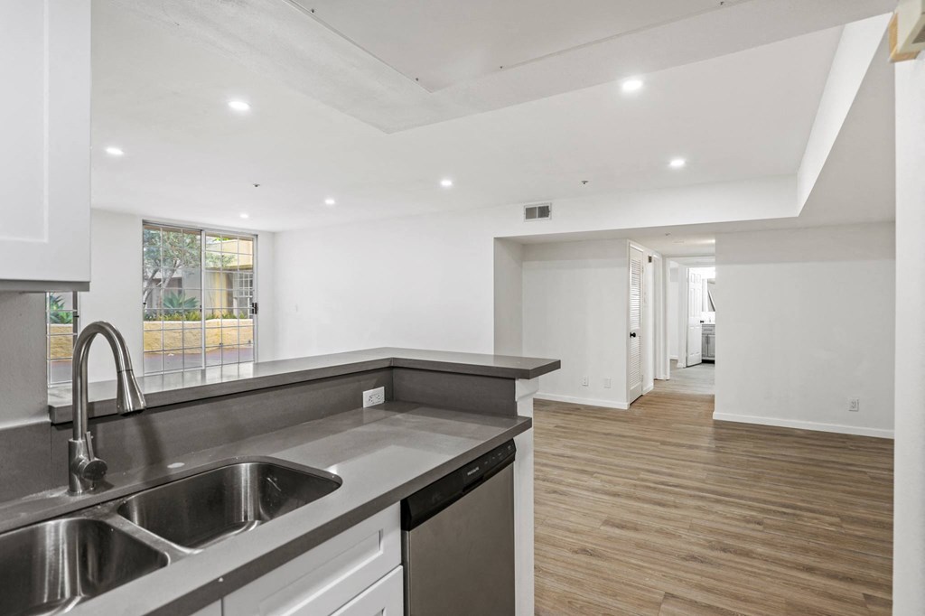 Open-Concept Kitchen and Dining Area with Recessed Lighting and Vinyl Flooring