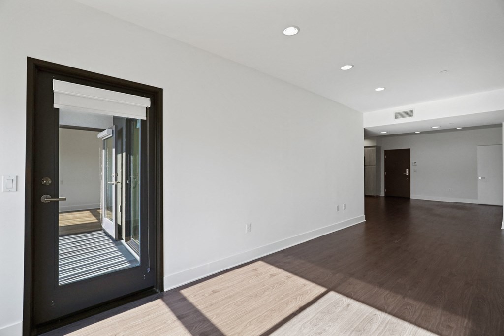 Open-Concept Kitchen, Dining, and Living Room Areas with Patio