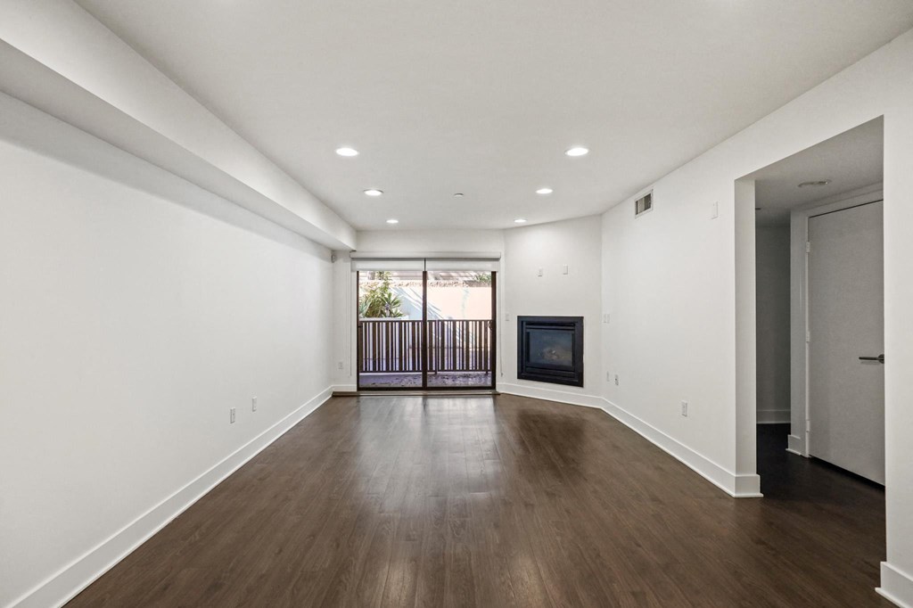 Living Room with Electric Fireplace, Recessed Lighting, Vinyl Flooring, and Patio
