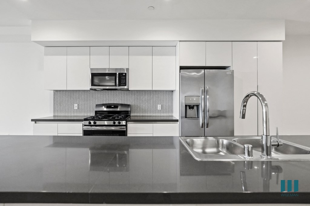 Open-Concept Kitchen with Energy-Efficient Appliances and Countertop Bar