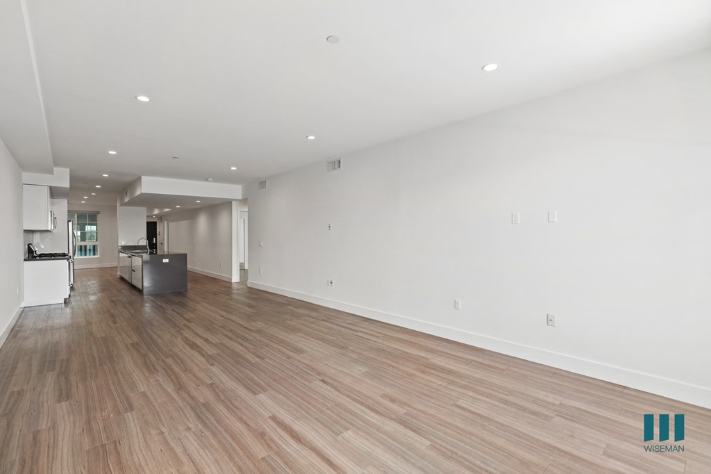 Spacious Living Room with Recessed Lighting and Vinyl Flooring