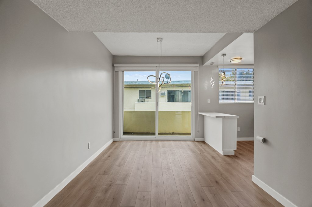 Open-Concept Kitchen, Dining, and Living Room Areas with Patio