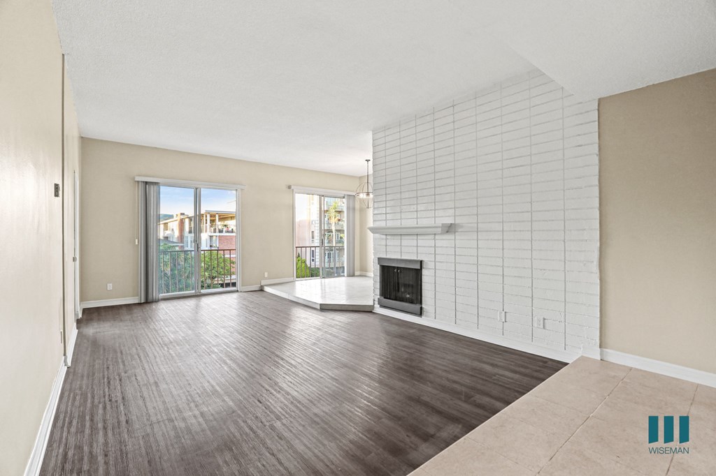 Living Room with Electric Fireplace, Vinyl Flooring, and Balcony