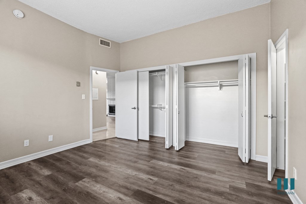 Bedroom with Double Closets and Vinyl Flooring